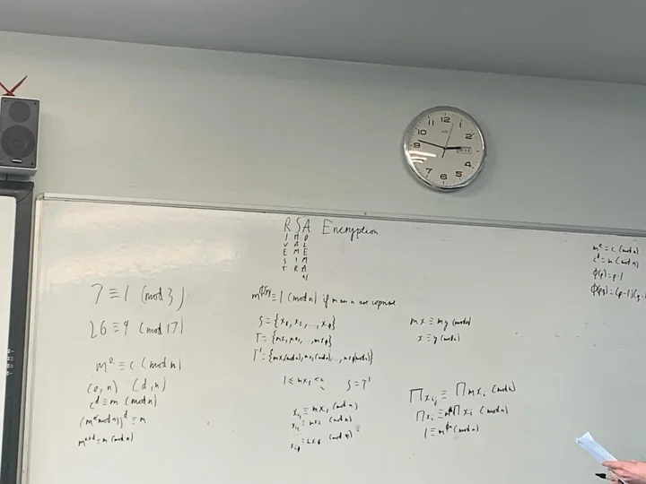 Whiteboard with handwritten maths