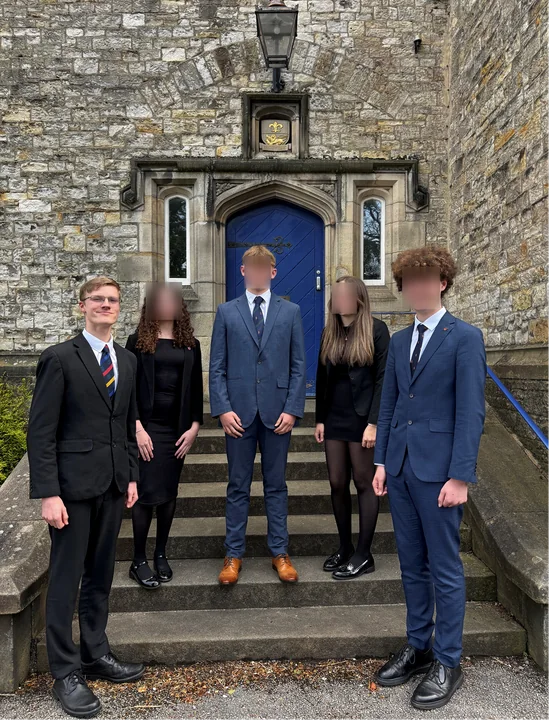 A school prefect group on stone steps